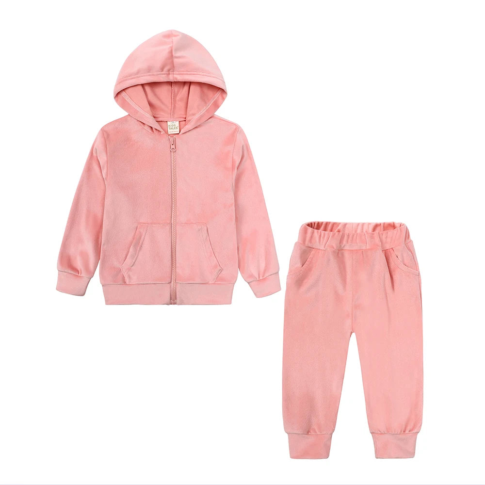 A pink velvet kids tracksuit set featuring a hooded zipper jacket and matching pants.