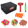 A set of party game components including a box, orange straws, and colorful balloons.