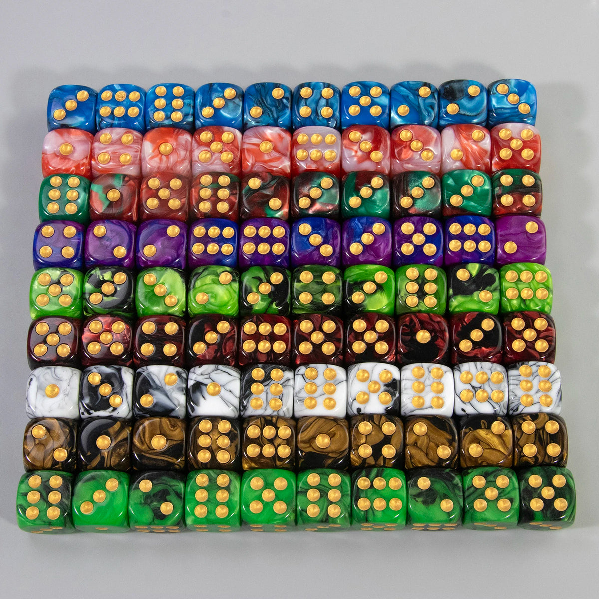 A set of ten multicolor acrylic dice with rounded corners arranged in a grid.