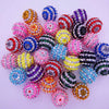 A collection of mixed two-tone striped resin beads in various colors and sizes for jewelry making