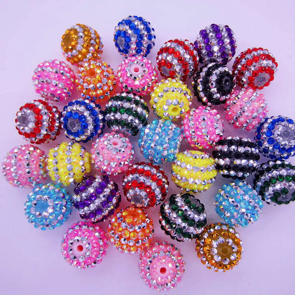 A collection of mixed two-tone striped resin beads in various colors and sizes for jewelry making