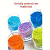 A collection of brightly colored raw materials including blue, purple, orange, and green granular substances in glass contain