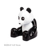 A white and black panda building block figure with large eyes.