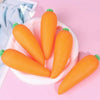 A pile of bright orange carrots arranged on a white plate.