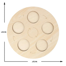 A wooden learning set with six circular cutouts arranged in a circle for teaching the animal and plant life cycle.