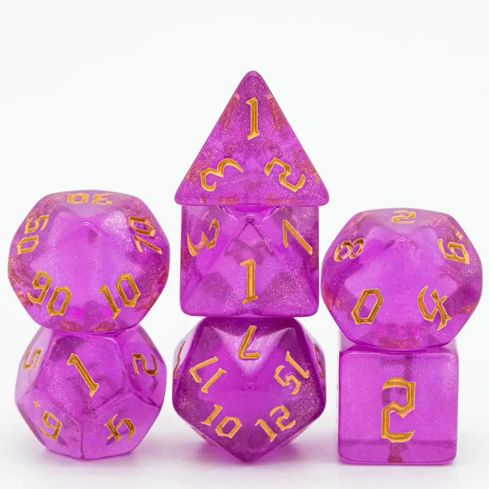 A set of seven glitter translucent polyhedral dice in various shapes and colors.