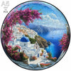 A jigsaw puzzle depicting a vibrant Mediterranean town with white buildings, pink flowering trees, and blue sea.