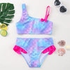 A vibrant purple and blue two-piece swimsuit set for girls featuring scale patterns and pink trim.