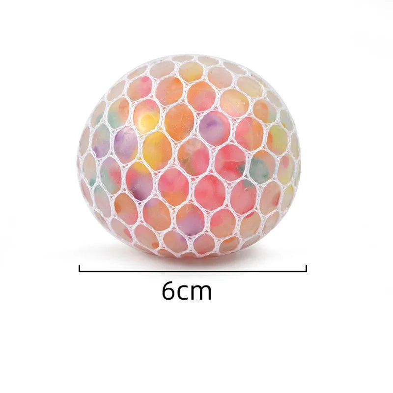 A rainbow squishy stress relief ball with a translucent, honeycomb-like exterior filled with colorful, marbled liquid.