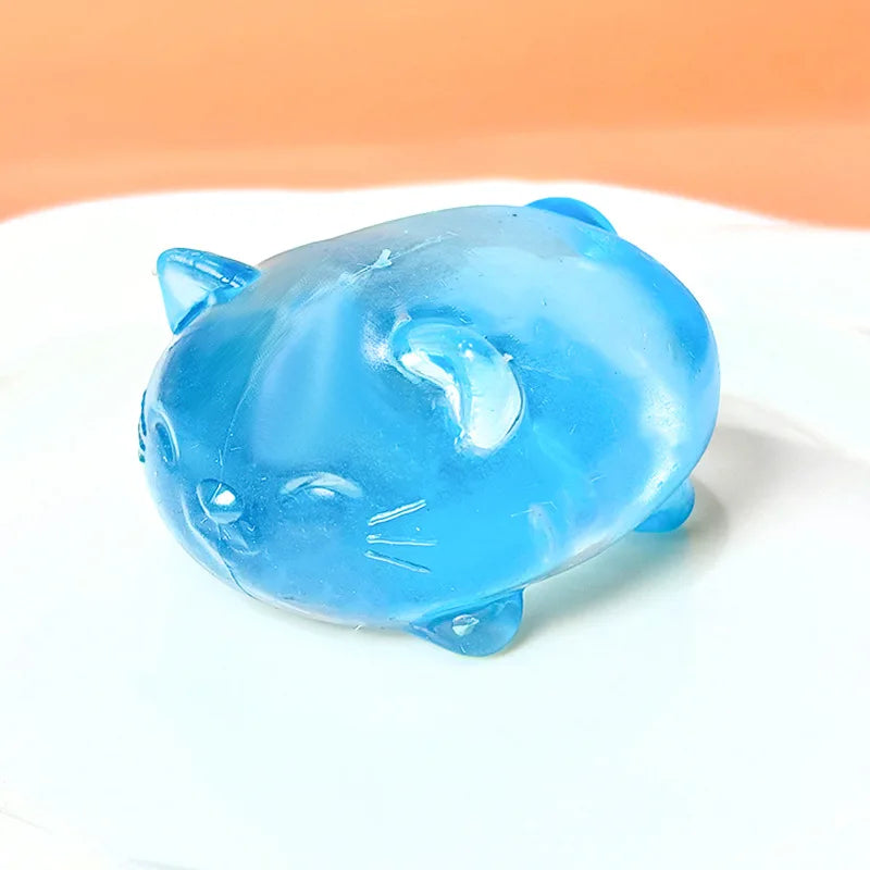 A translucent blue cat squishy stress relief toy resting on a white surface.