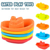 A set of colorful plastic bath toys including a boat and beach toy in various shades of orange, yellow, blue, and red.