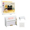 A wooden miniature piano set with a black keyboard and pink bench, shown next to a box featuring animal figures.