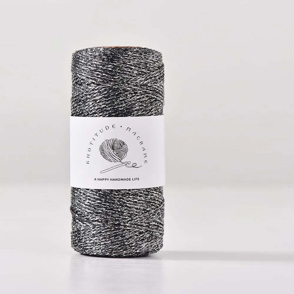 Spool of black metallic yarn for knitting and crochet thread