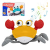 A yellow and gray interactive crab toy with large eyes and claws is shown against a white background.