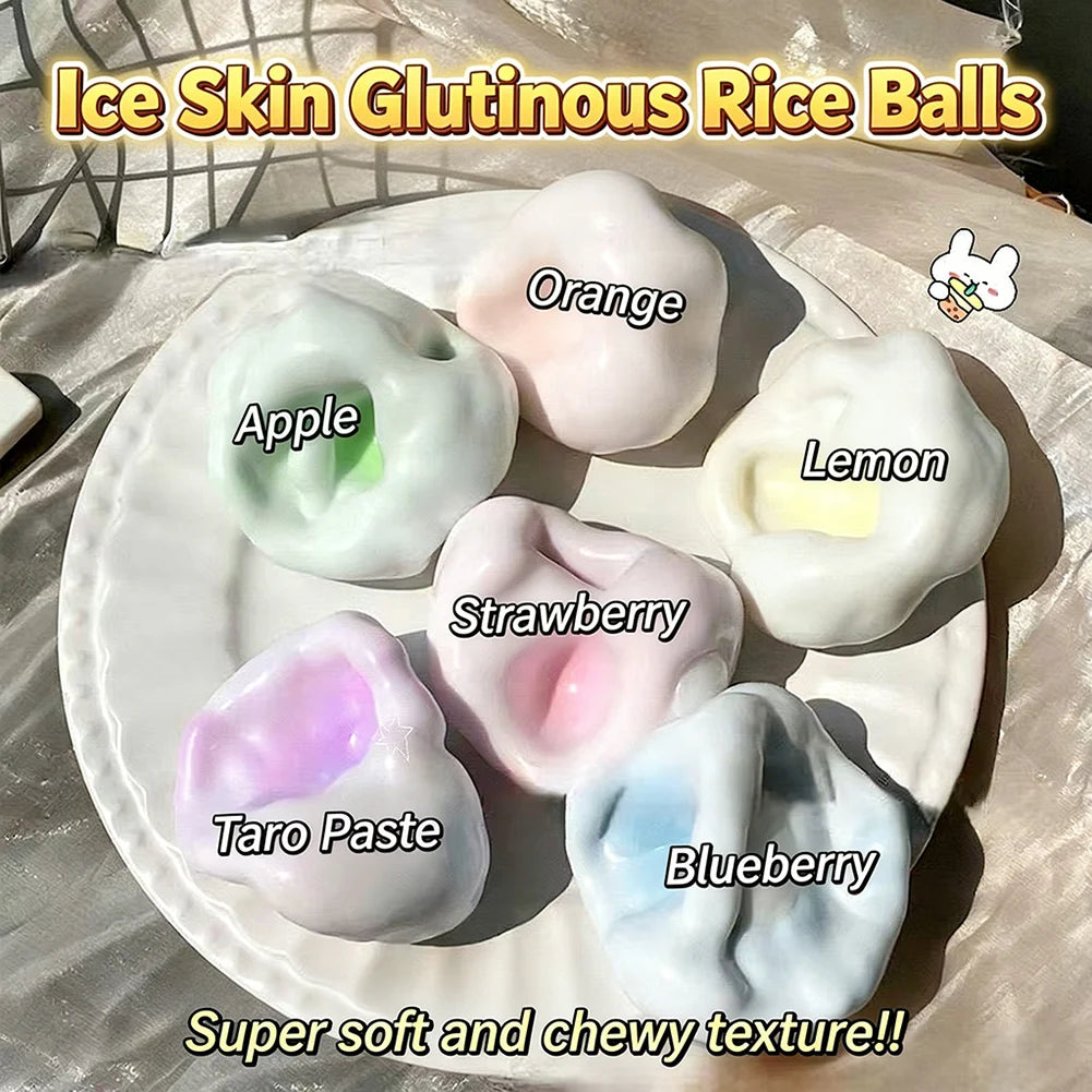 A variety of soft squishy balls in colors like orange, lemon, strawberry, and blueberry are displayed on a white plate.