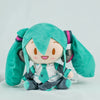 A cute teal Hatsune Miku plush doll with long hair and headphones sitting on a white surface.