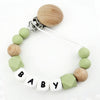 A necklace featuring wooden and silicone teething beads attached to a clip for a baby pacifier.