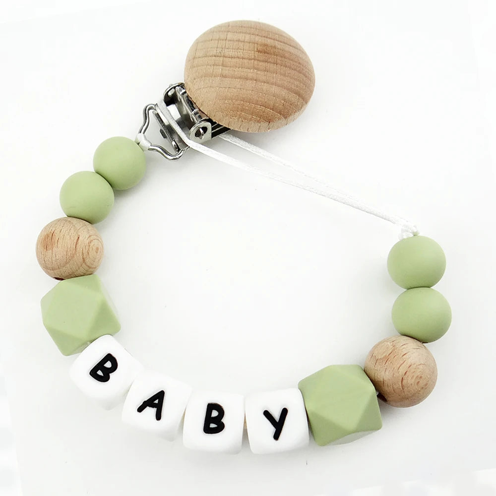 A necklace featuring wooden and silicone teething beads attached to a clip for a baby pacifier.