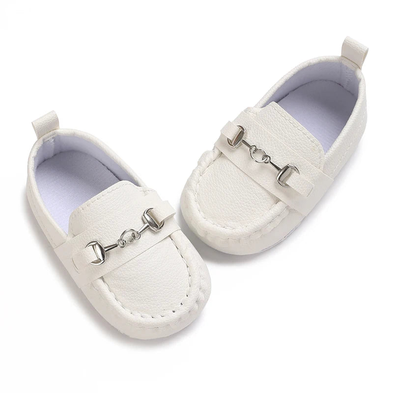 White baby first walker sneakers with a dinosaur print detail