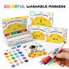 A set of colorful washable markers and a sheet of paper featuring a space theme illustration.