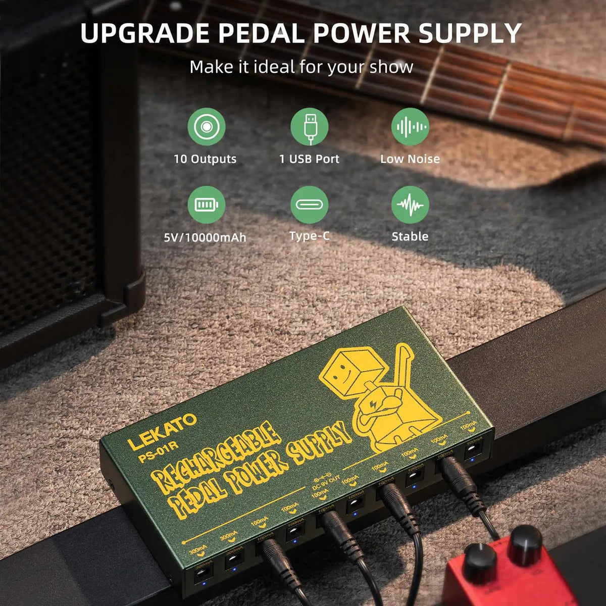 A green portable rechargeable guitar pedal power supply with multiple DC outputs is shown on a wooden surface.