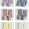 Three pairs of baby anti-slip fleece socks in various shades of gray and beige.
