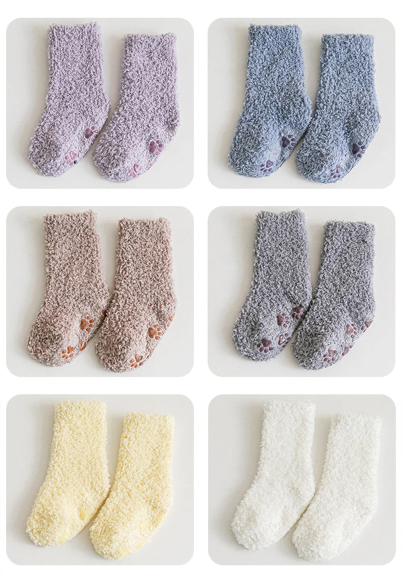 Three pairs of baby anti-slip fleece socks in various shades of gray and beige.