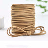 A stack of tan velvet faux suede braided ribbon rolls for crafting and gift wrapping.