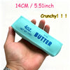 A hand holds a light blue silicone stress ball labeled 4oz salted butter with the text Crunchy!!!