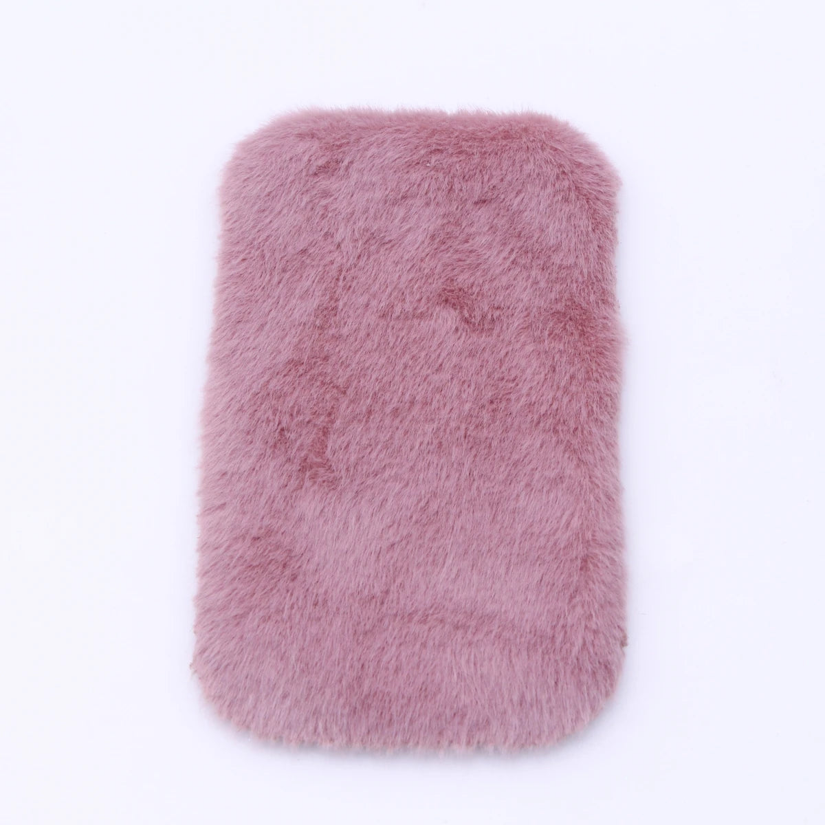 A rectangular, fluffy, dusty rose colored miniature carpet mat for dollhouse decor.