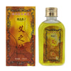 A glass bottle of Moxibustion Body Massage Oil with a brown label and gold cap.