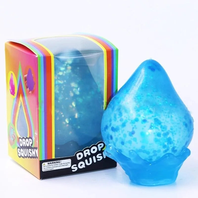 A blue squishy toy shaped like a raindrop is shown in its packaging.