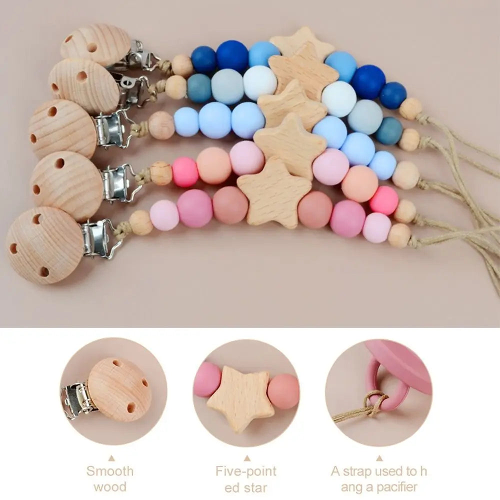 A string of wooden star shapes and silicone beads used as a baby pacifier clip