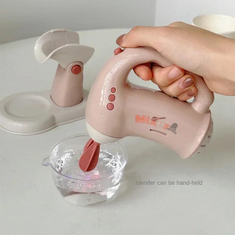 A hand is holding a pink blender with a purple blade over a glass of water.
