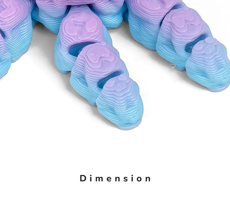 A close-up view of a set of purple and blue 3D printed articulated octopus fridge magnets.
