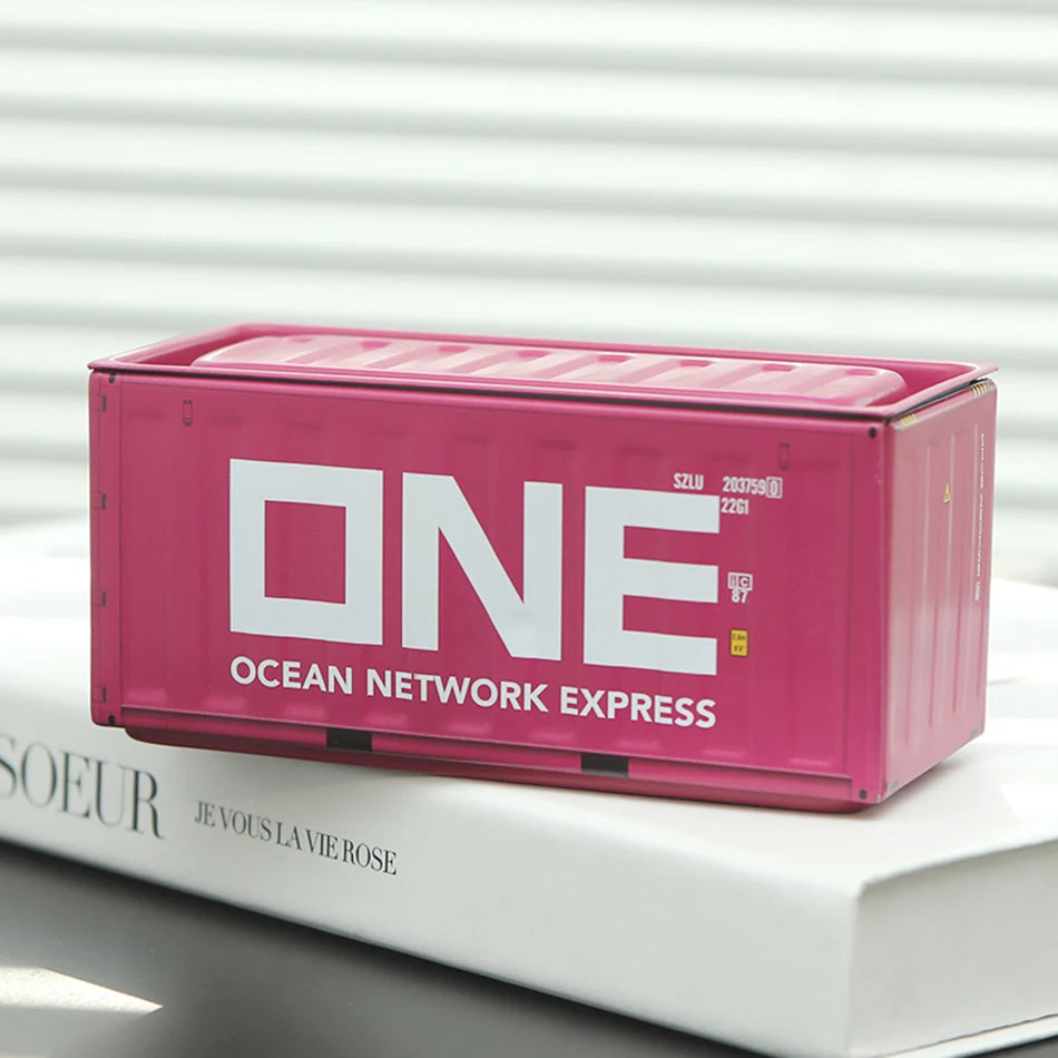 A pink industrial storage box labeled Ocean Network Express resting on a white book.