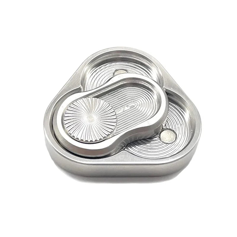 A silver metal fidget slider with a textured, oval design for stress relief.
