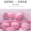 A collection of pink pig squishy stress relief toys in clear plastic packaging.
