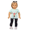A doll wearing a light blue unicorn pajama set with a floral design and dark leggings.
