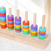 Wooden ring toss game showing colored wooden rings stacked in a row for sorting and stacking.