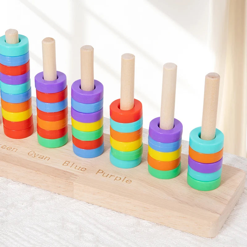 Wooden ring toss game showing colored wooden rings stacked in a row for sorting and stacking.