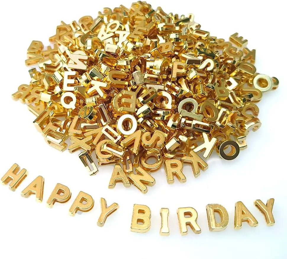 A pile of gold-colored acrylic alphabet letter beads for jewelry making and crafts