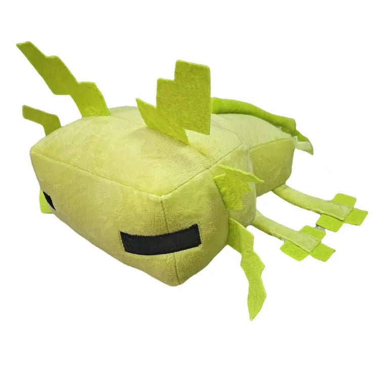 A soft, lime green plush toy shaped like an axolotl with spiky features and a black eye patch.