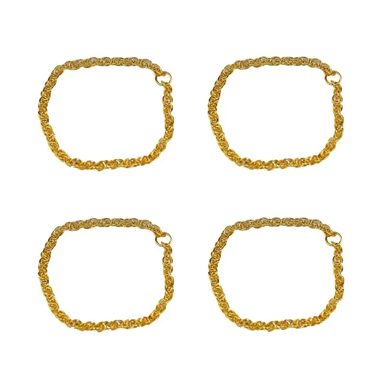 A set of four gold-colored rubber duck accessories including rings, sunglasses, and hats.