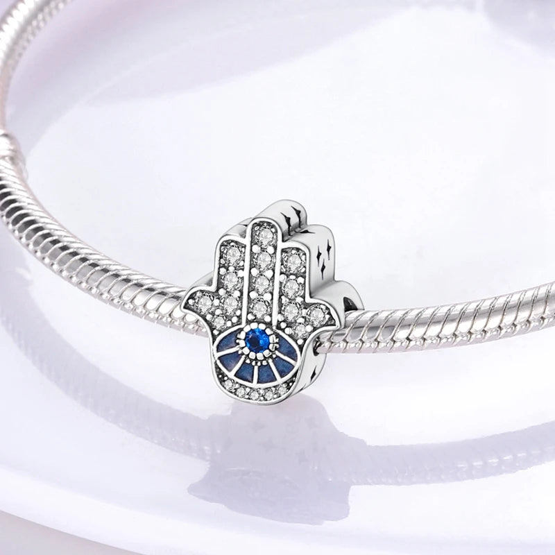 Sterling silver charm beads set featuring cross, angel, and evil eye designs for DIY jewelry making