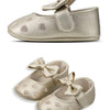 Gold glitter baby girl shoes with a bow knot design and soft anti-slip sole