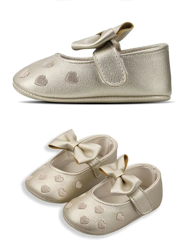 Gold glitter baby girl shoes with a bow knot design and soft anti-slip sole
