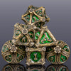 A stack of seven metal dice in gold and green, used for tabletop role-playing games.