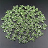 A pile of 20 clear green acrylic bow beads for jewelry making