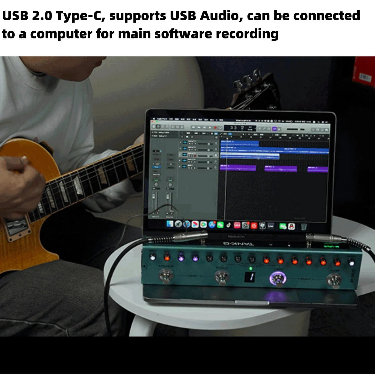 A portable guitar multi-effects processor is connected to a computer for software recording.